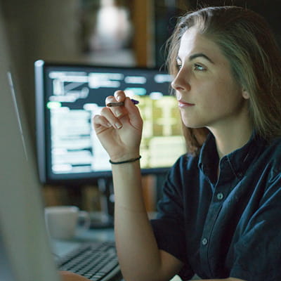 Young woman working at computer screen