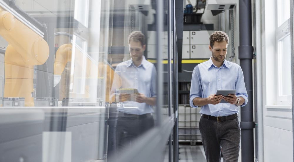 Minimum information guidelines elearning - Young man checking his digital tablet standing in a commercial property