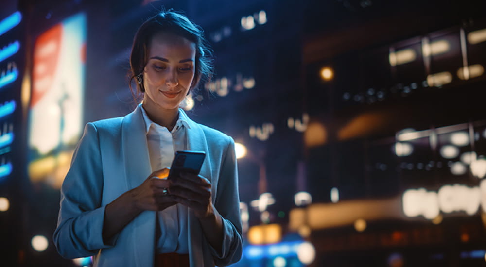 Business woman looking at mobile phone