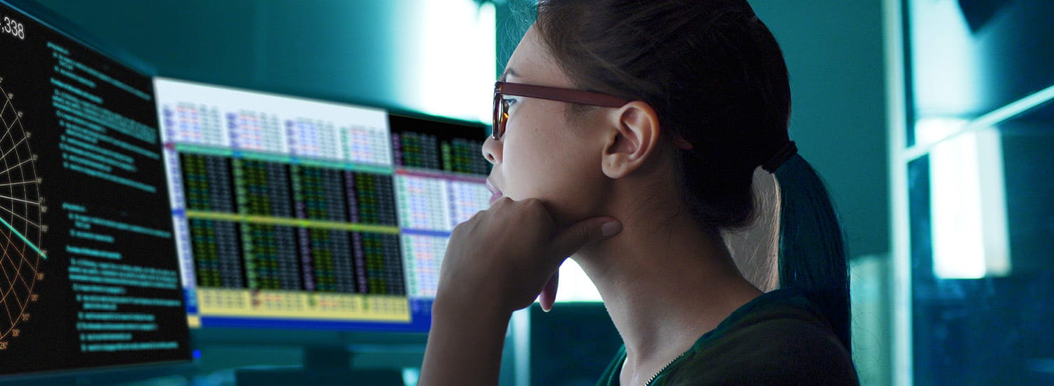 Woman looking at monitors