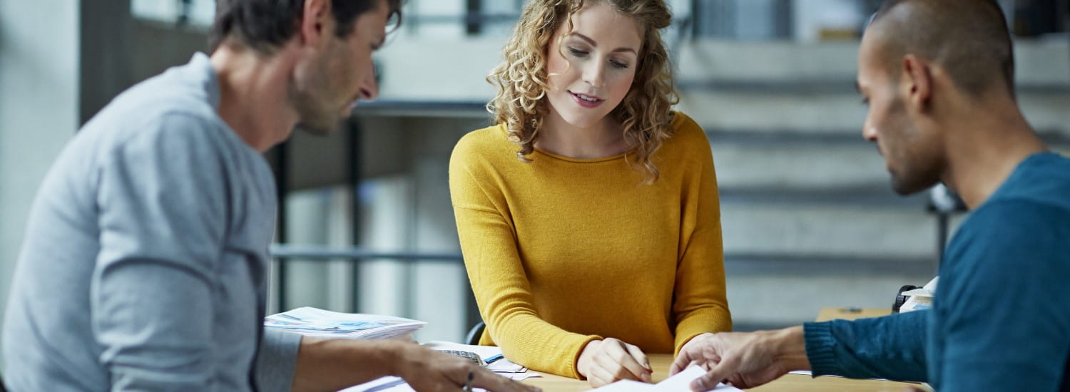 Two men and a woman collaborating at work